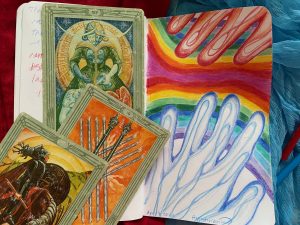 One blue hand reaching towards a red hand over a mirror rainbow sky, Art Card Ten of Wands, Knight of Disks.